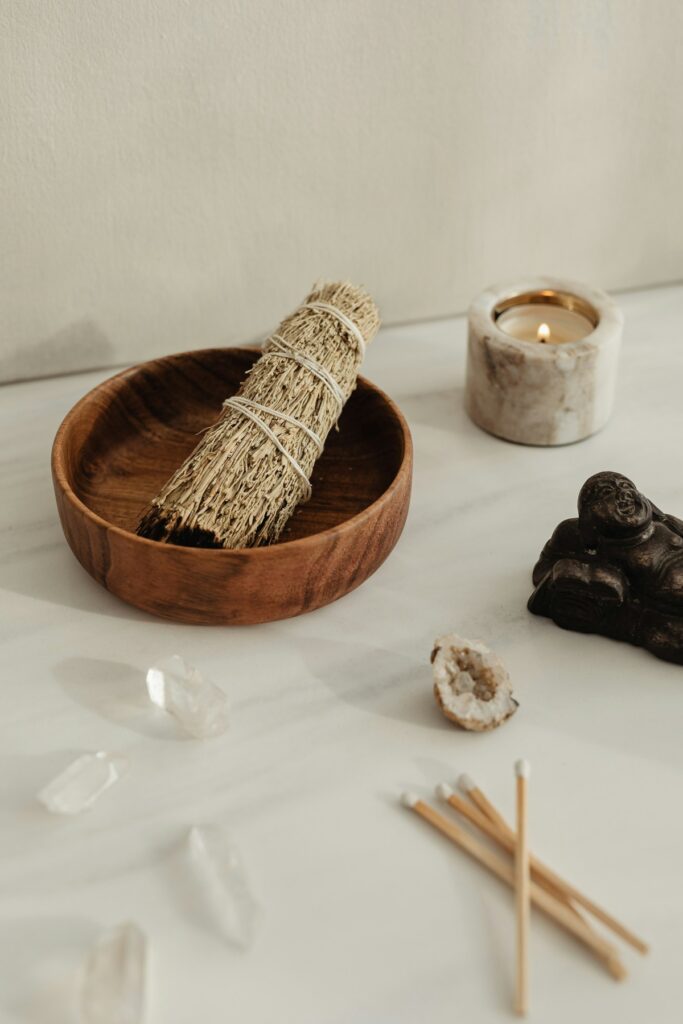 Crystals along with a candle smudging bundle.