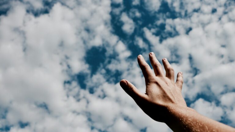 Hand reaching sky.