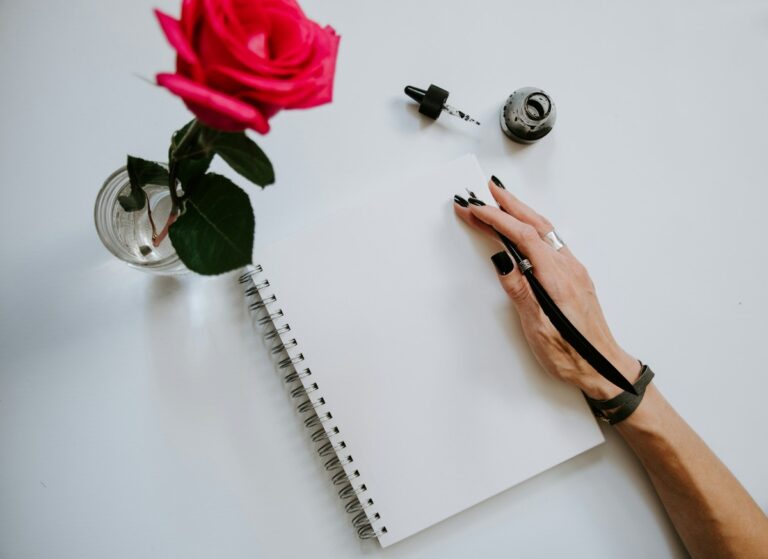 Woman's hand over notebook.