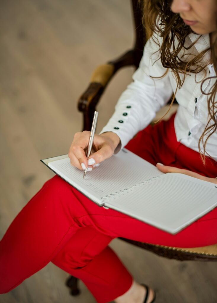 Woman writing on notebook.