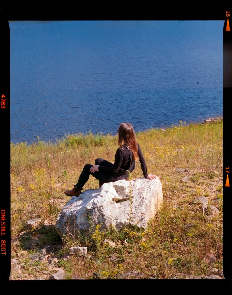 Woman sitting on a rock.