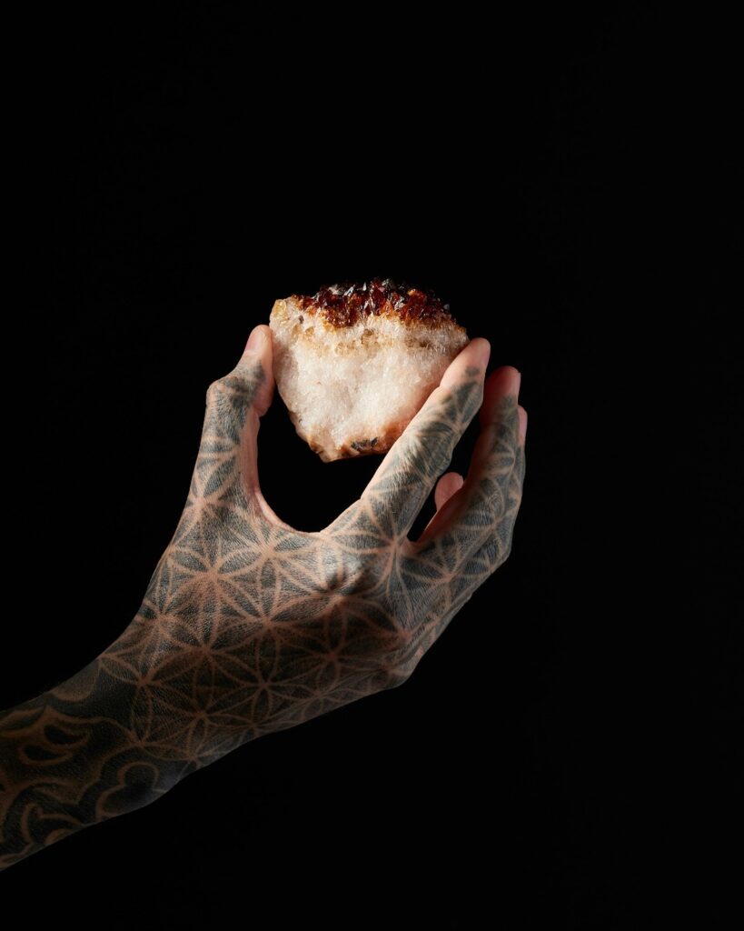 Hand holding crystal.