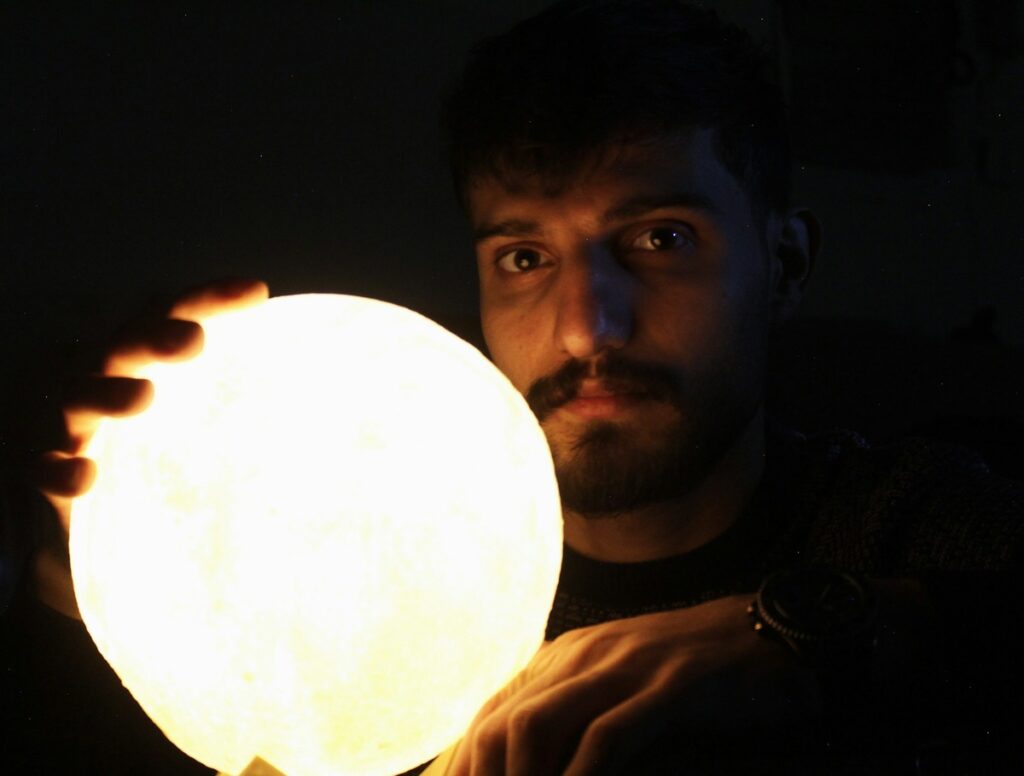 Man hodling glowing sphere.