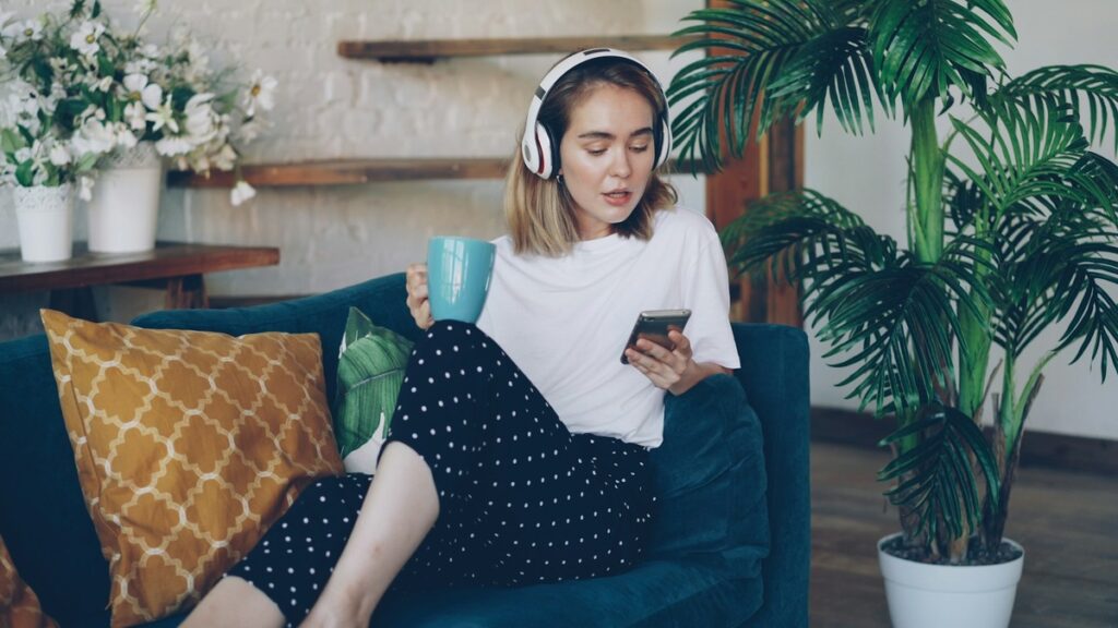 Woman listening to music, enjoying tea.